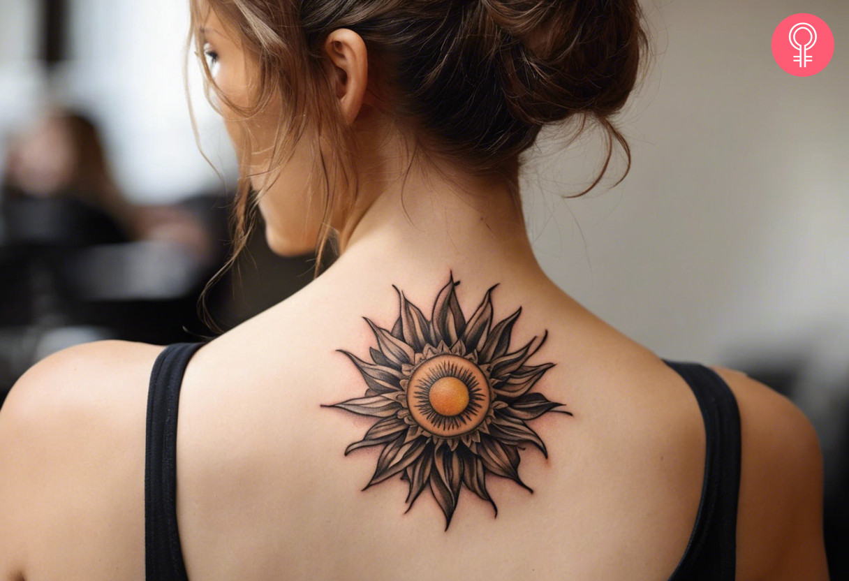 Woman with realistic sun tattoo on her upper back