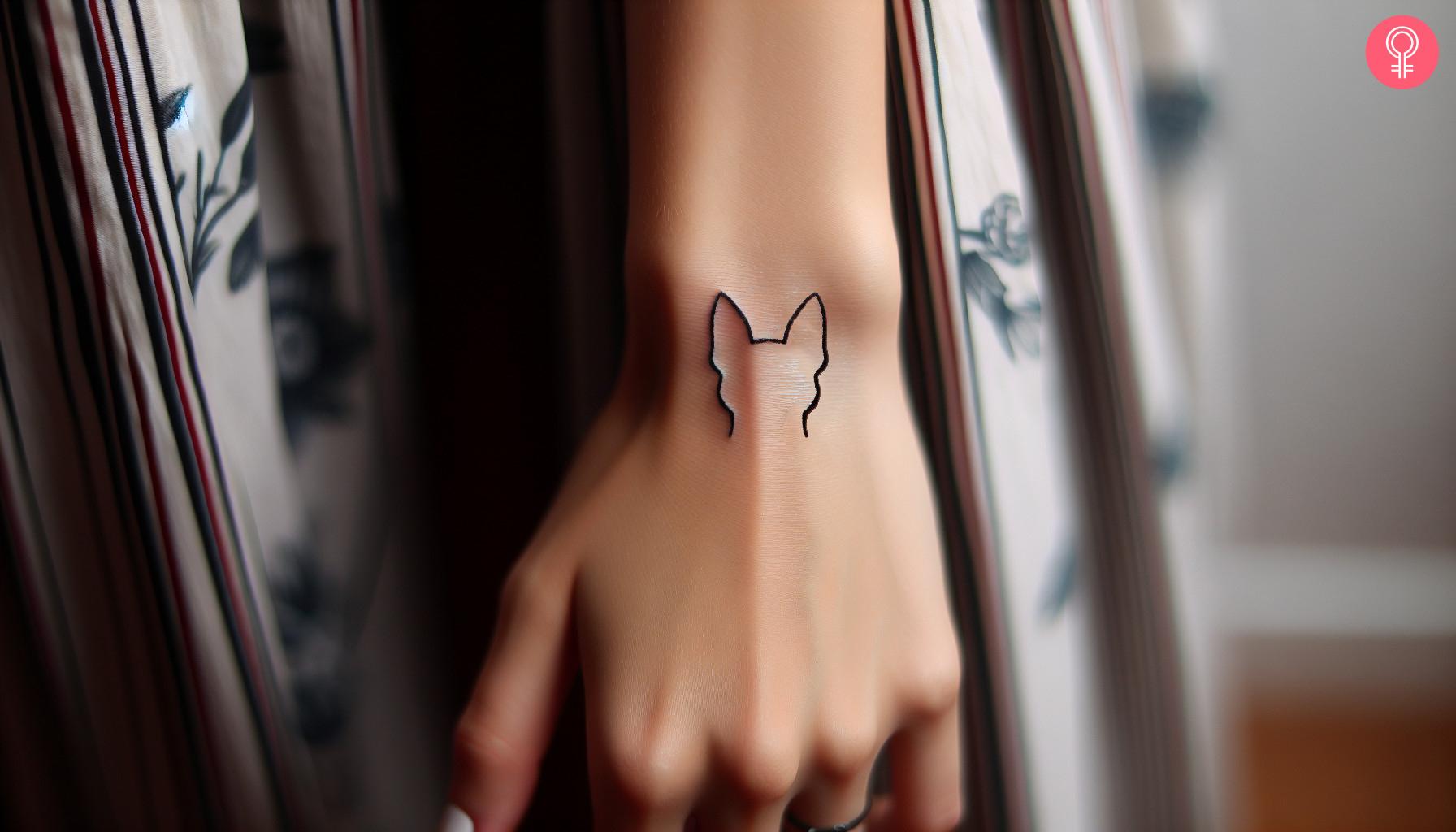 Woman with schnauzer ear tattoo on her hand