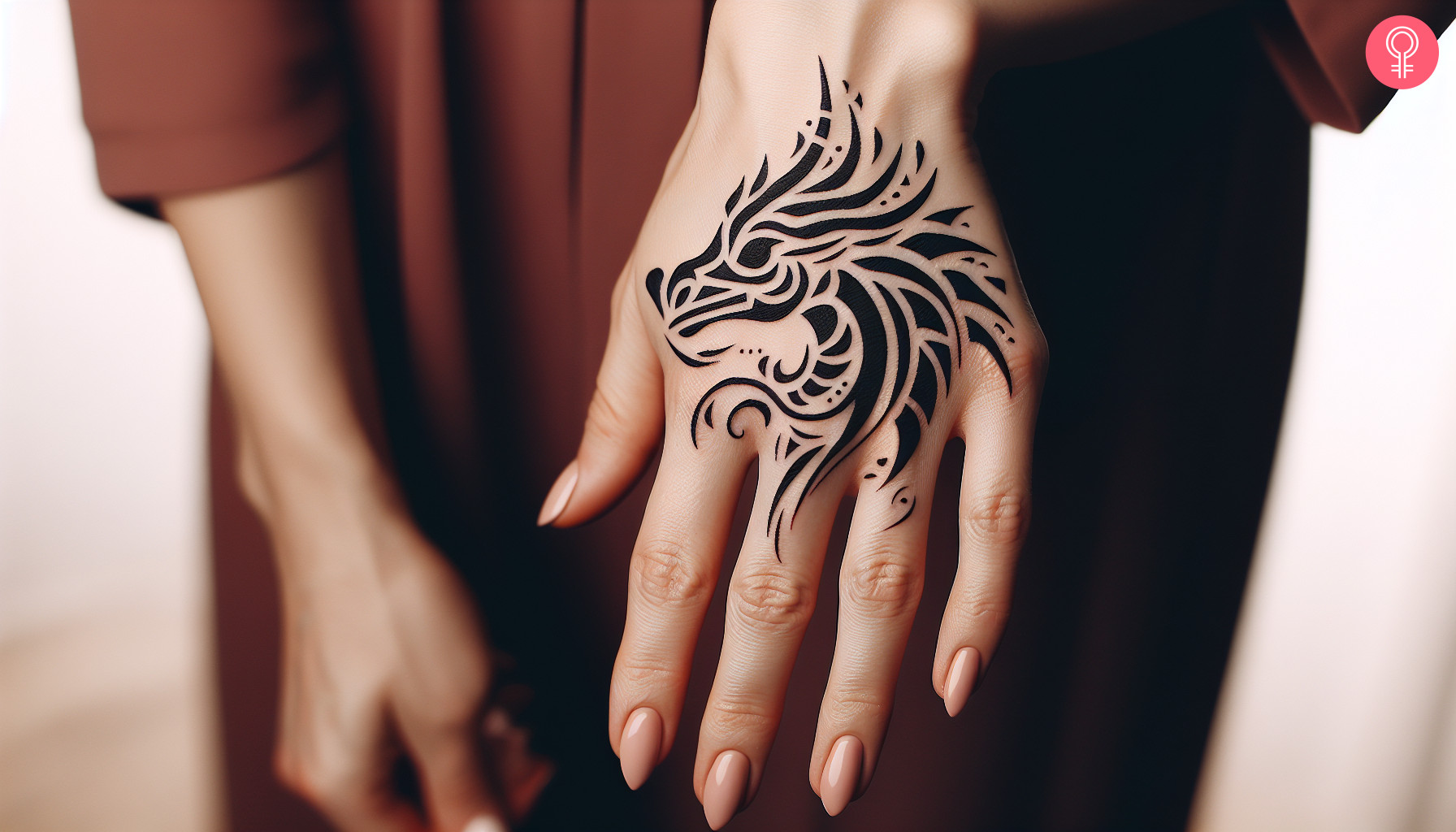 Woman with tribal dragon head tattoo on her hand