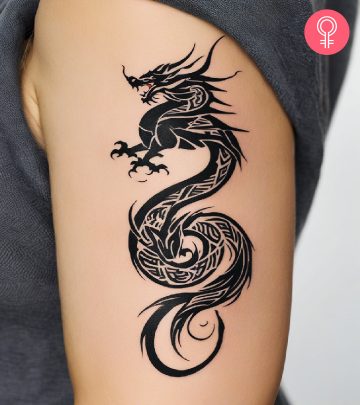 A black ink dragon calf tattoo