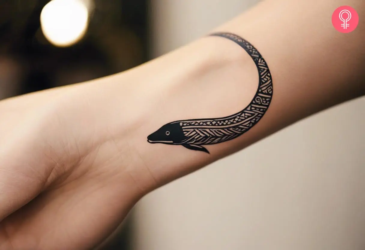 Woman with tribal eel tattoo on her wrist