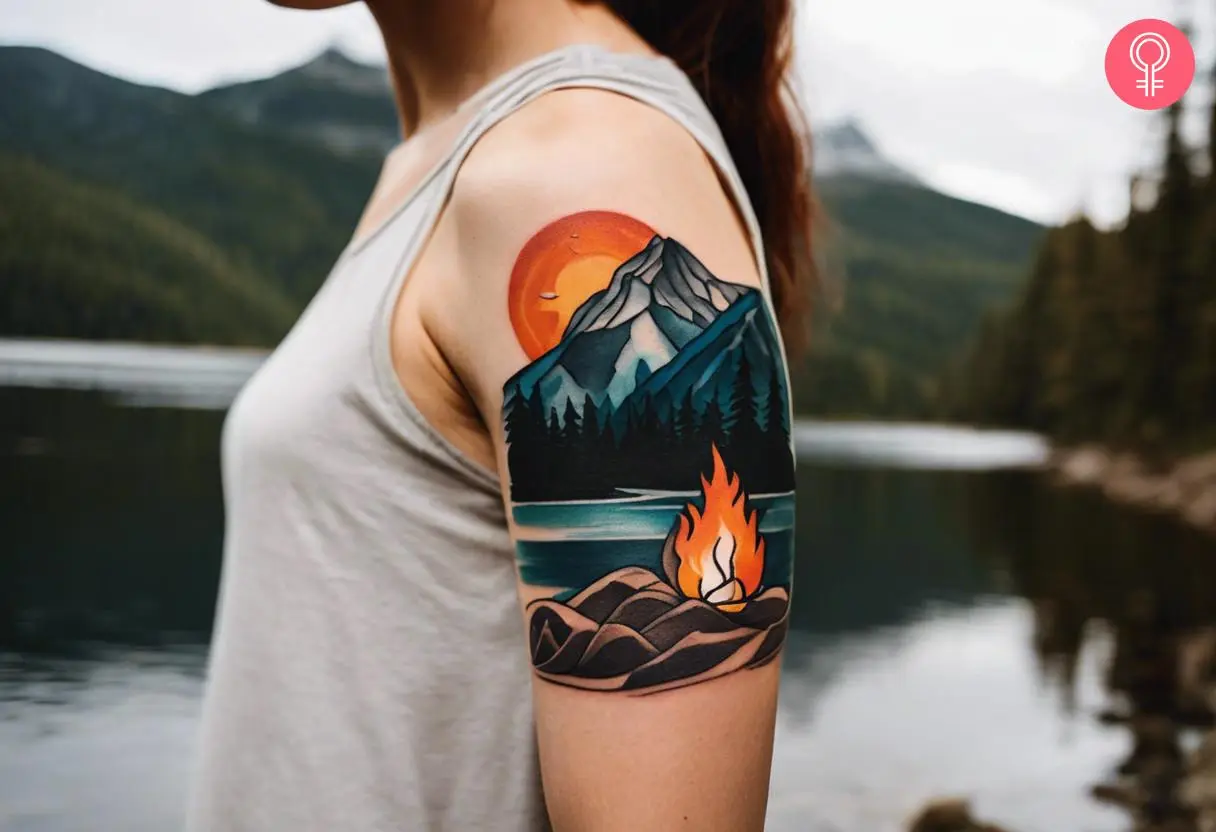 Woman with wilderness campfire tattoo on her upper arm