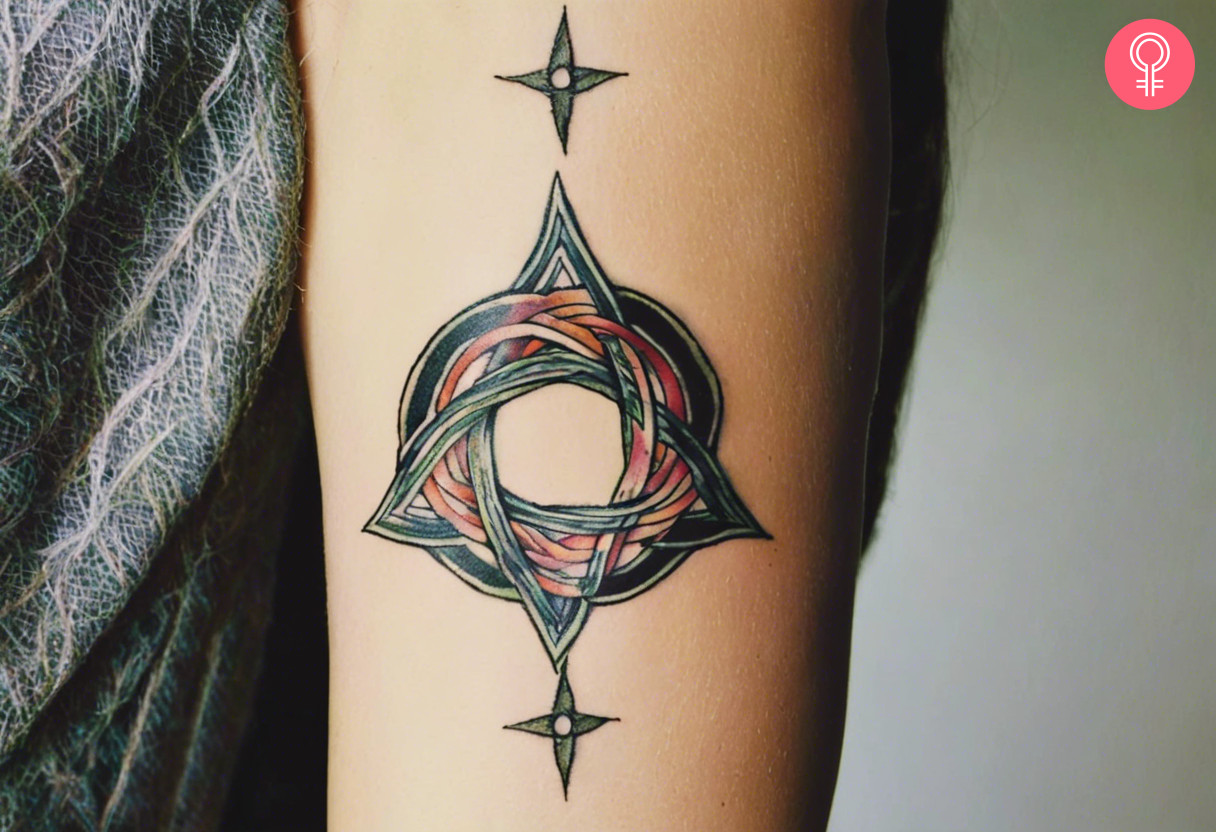 Woman with witches knot tattoo on her outer arm