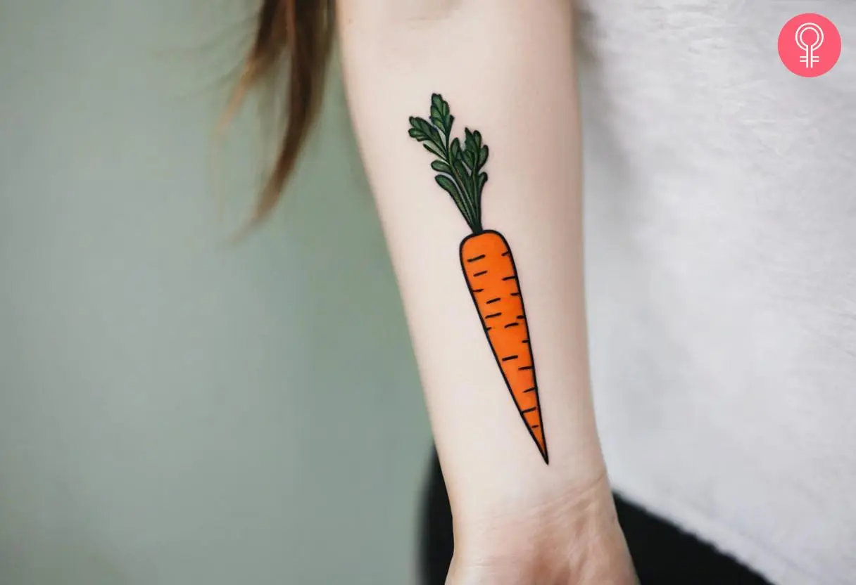 A colorful carrot tattoo inked on the forearm