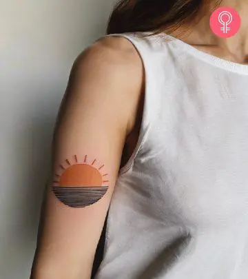 Woman with sun tattoo on her arm