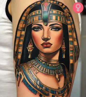 A woman with a colored Cleopatra tattoo on her upper arm