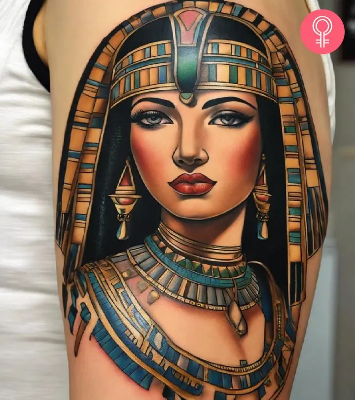 A woman with a colored Cleopatra tattoo on her upper arm