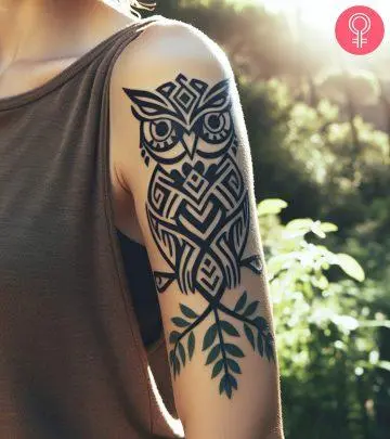 A man with an elaborate shoulder tribal tattoo design.