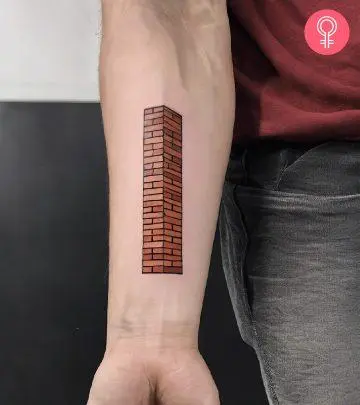 A brick column tattoo on the forearm