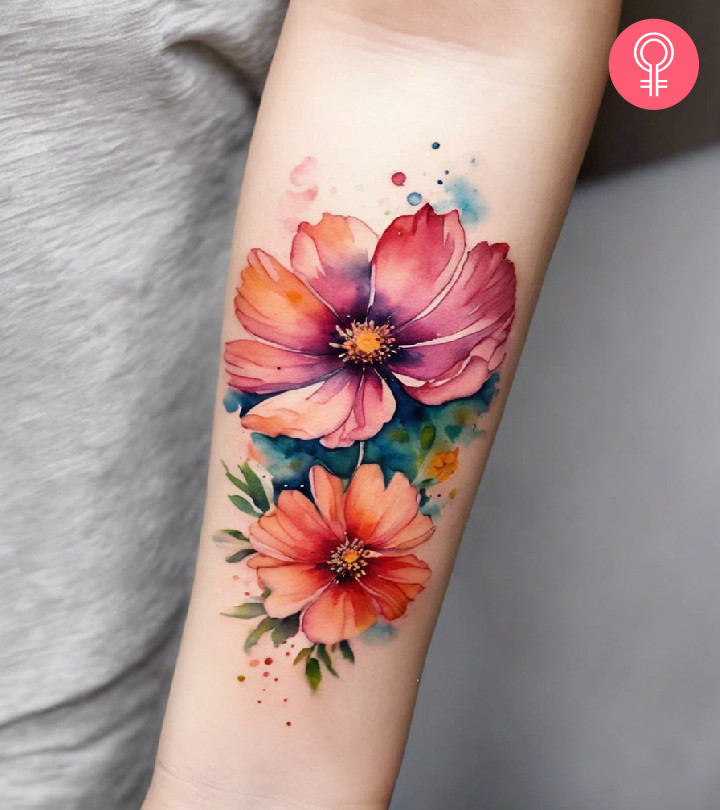 Two cosmos flowers inked on the forearm inked in watercolor style