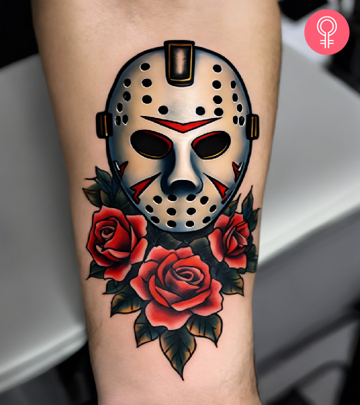 A traditional Jason mask tattoo with roses inked on the forearm