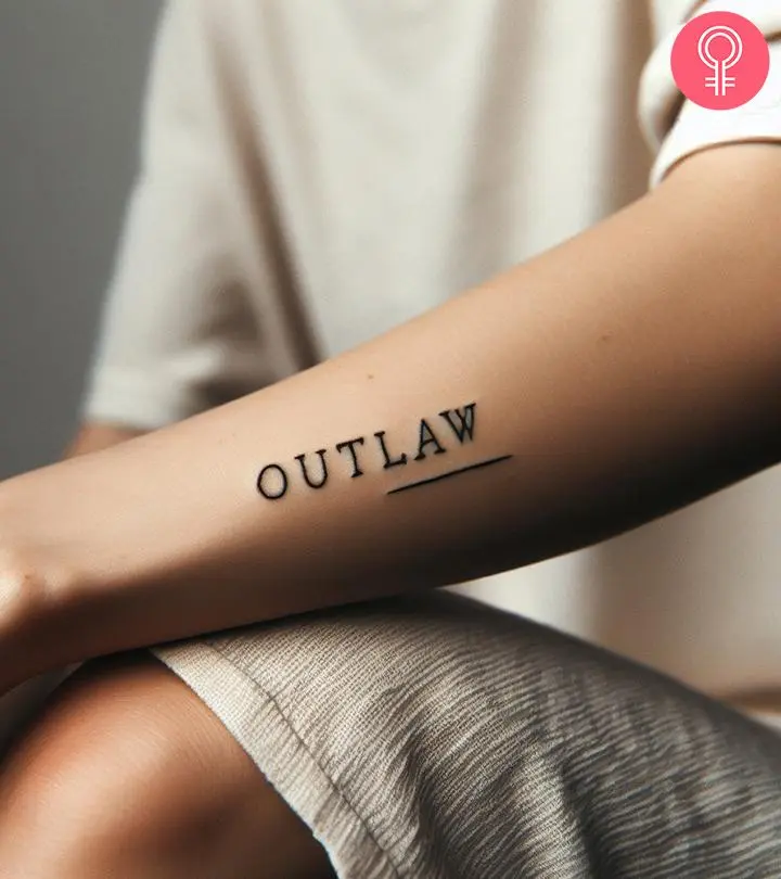 An outlaw text tattoo on the forearm