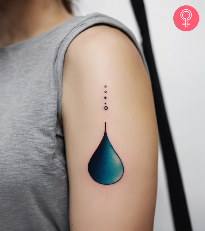 A woman with a colored water drop tattoo on her upper arm