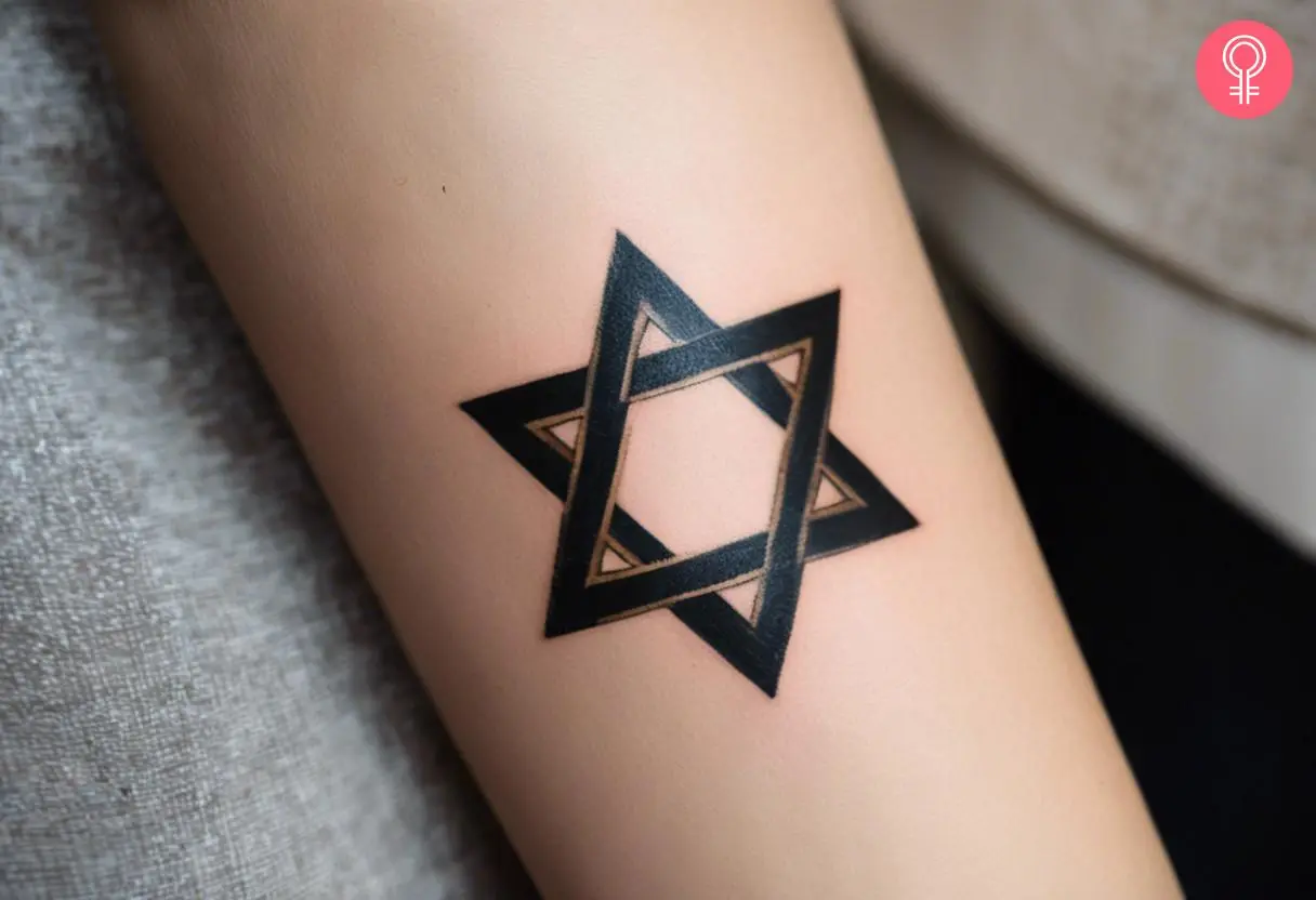 A Hebrew Star Of David tattoo on a woman’s forearm