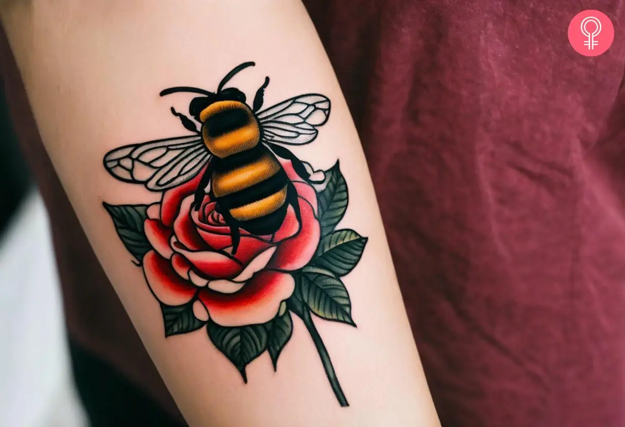 A bee and a rose tattoo on the forearm of a woman