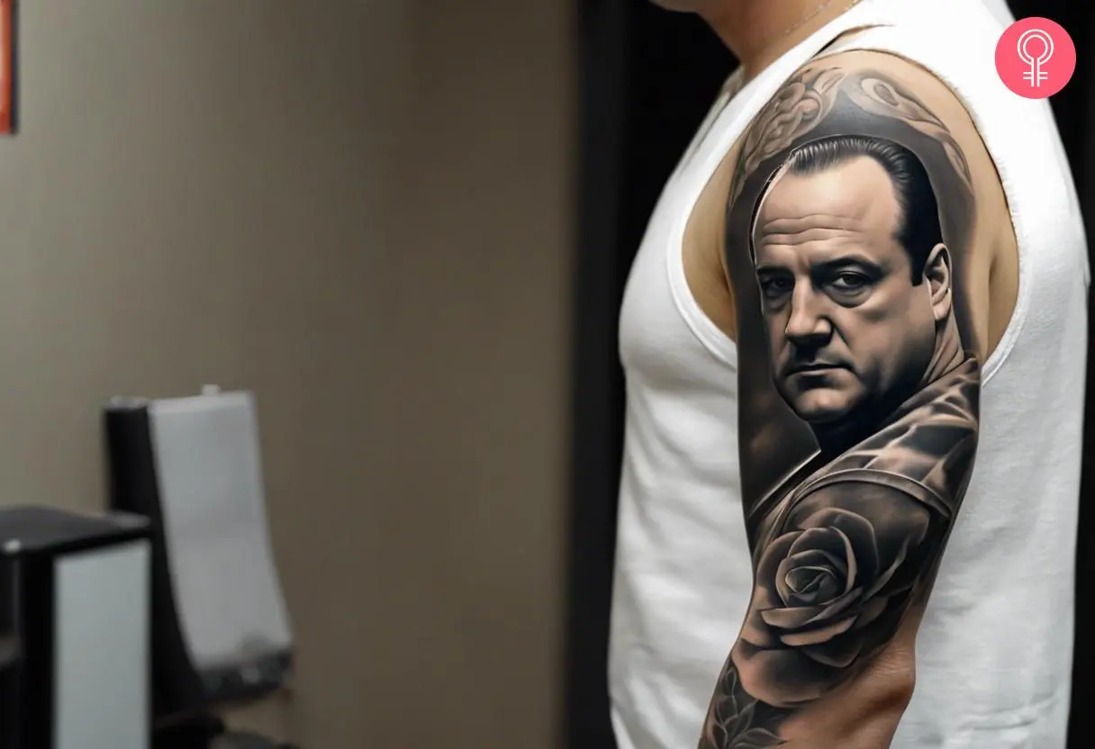 A black-and-grey Tony Soprano sleeve tattoo with a rose