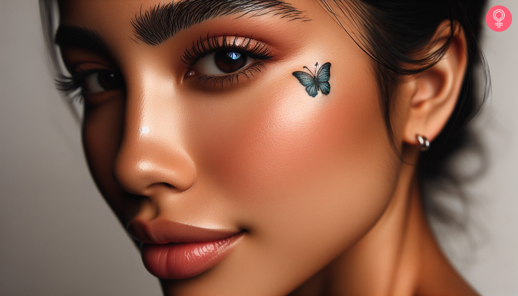 A blue and black butterfly tattoo right under the outer corner of the eye