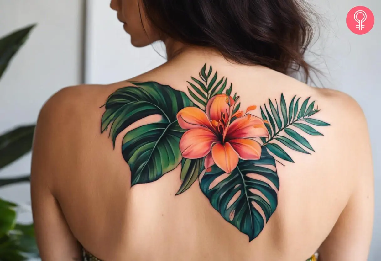 A colorful tropical foliage tattoo on the upper back