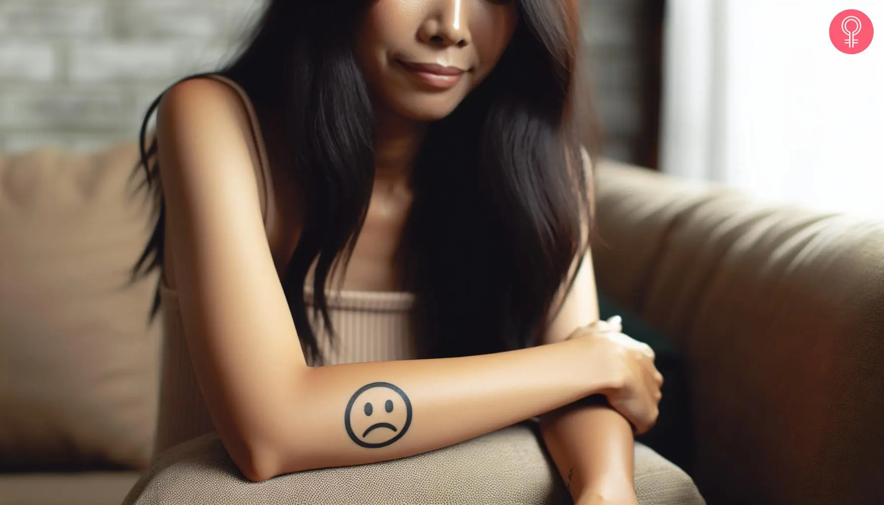 A face emoji tattoo on a woman’s arm