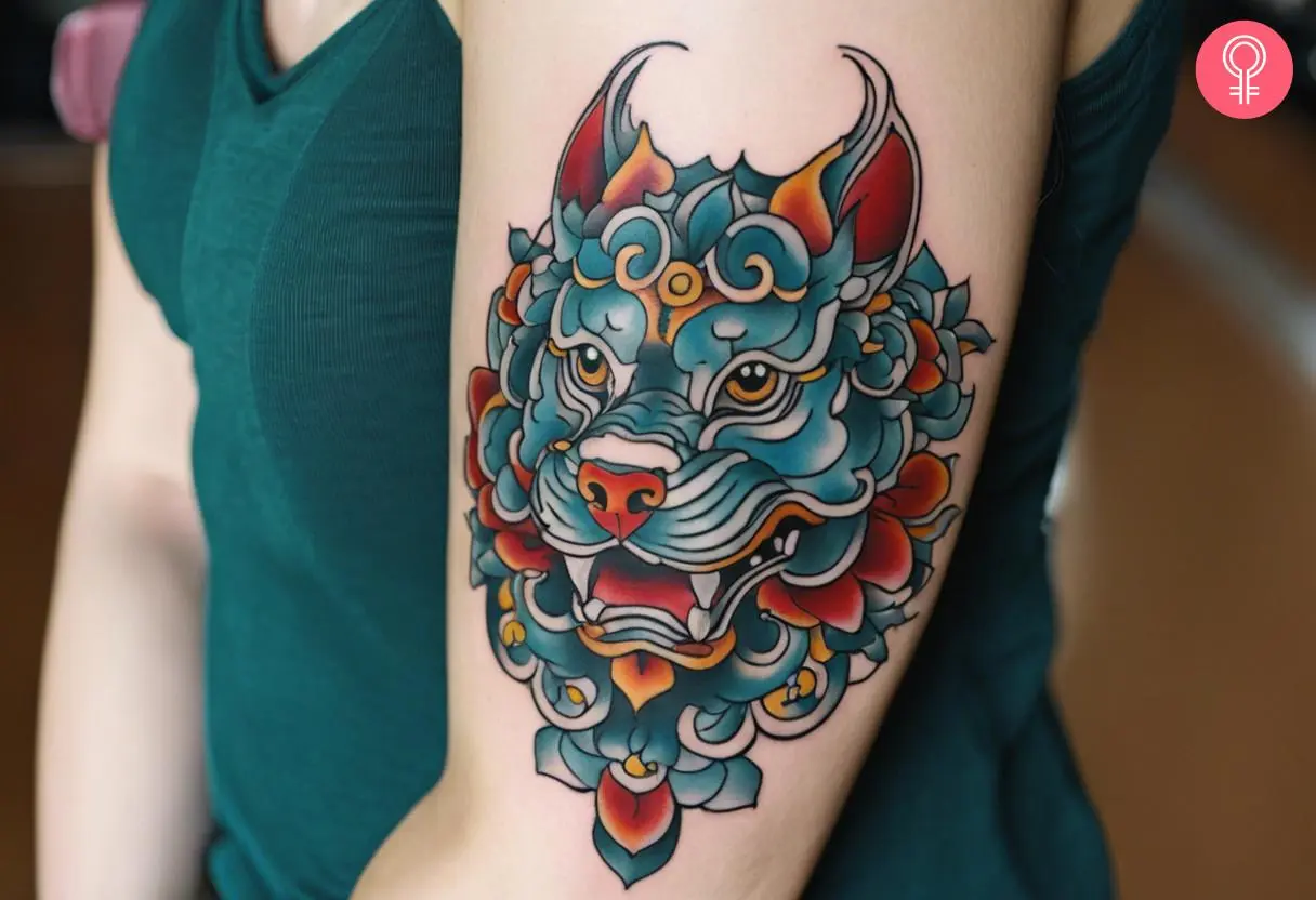 A feminine foo dog tattoo on the arm