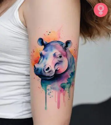 A hippo tattoo on the arm of a woman