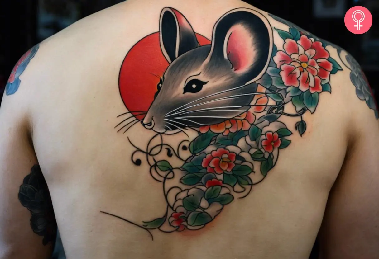 A man wearing a Japanese mouse tattoo on the back