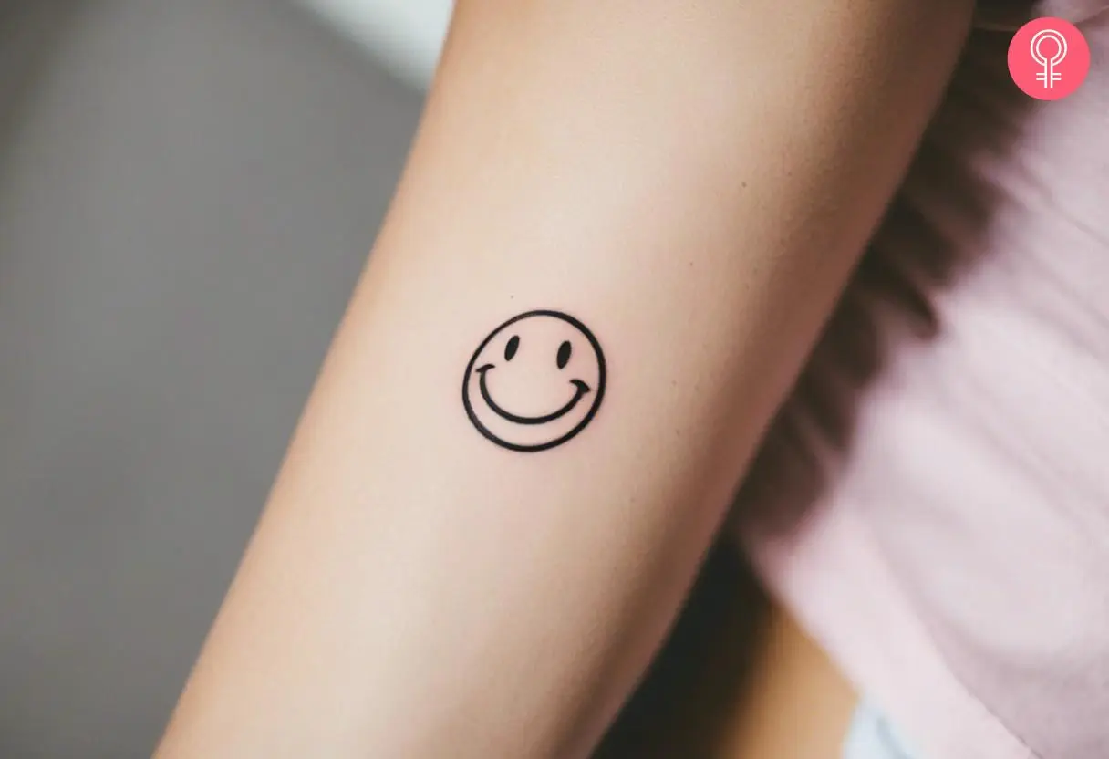 A minimalist smiley face doodle tattoo