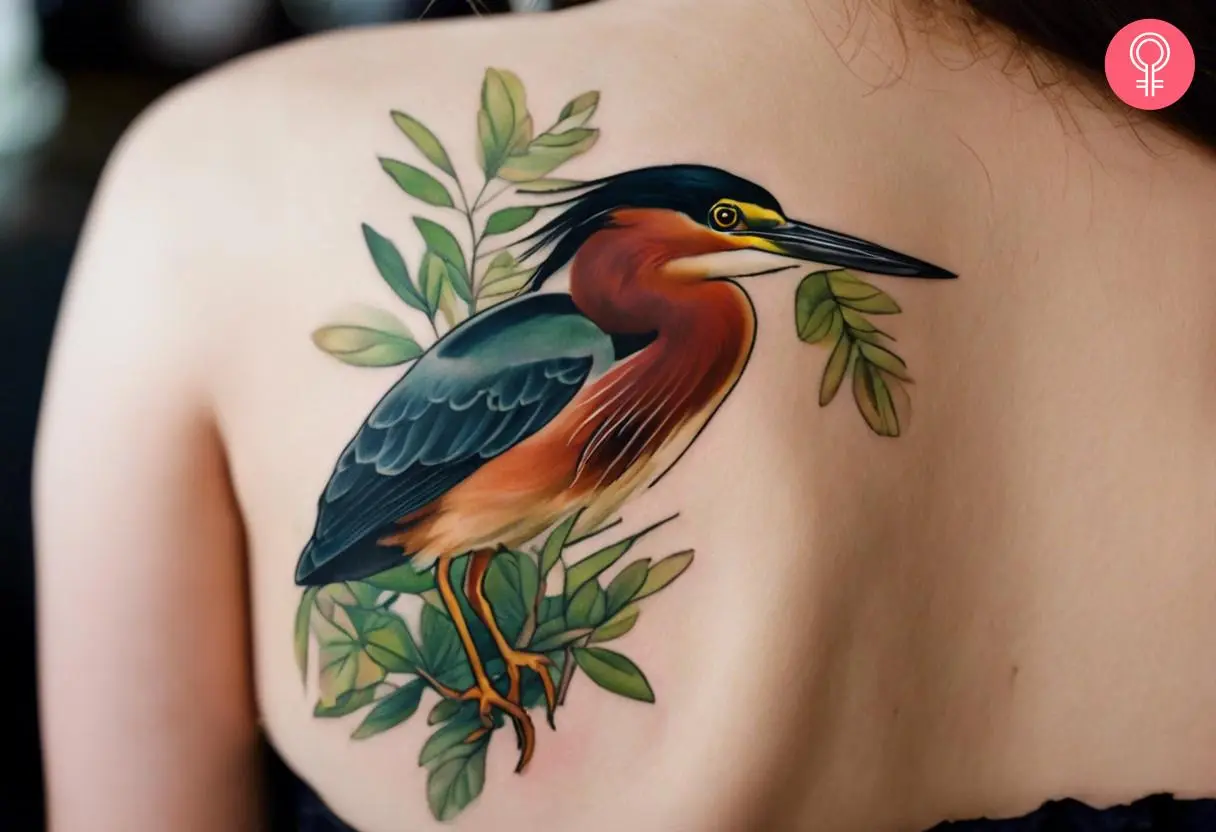 A tattoo of a heron surrounded by greenery