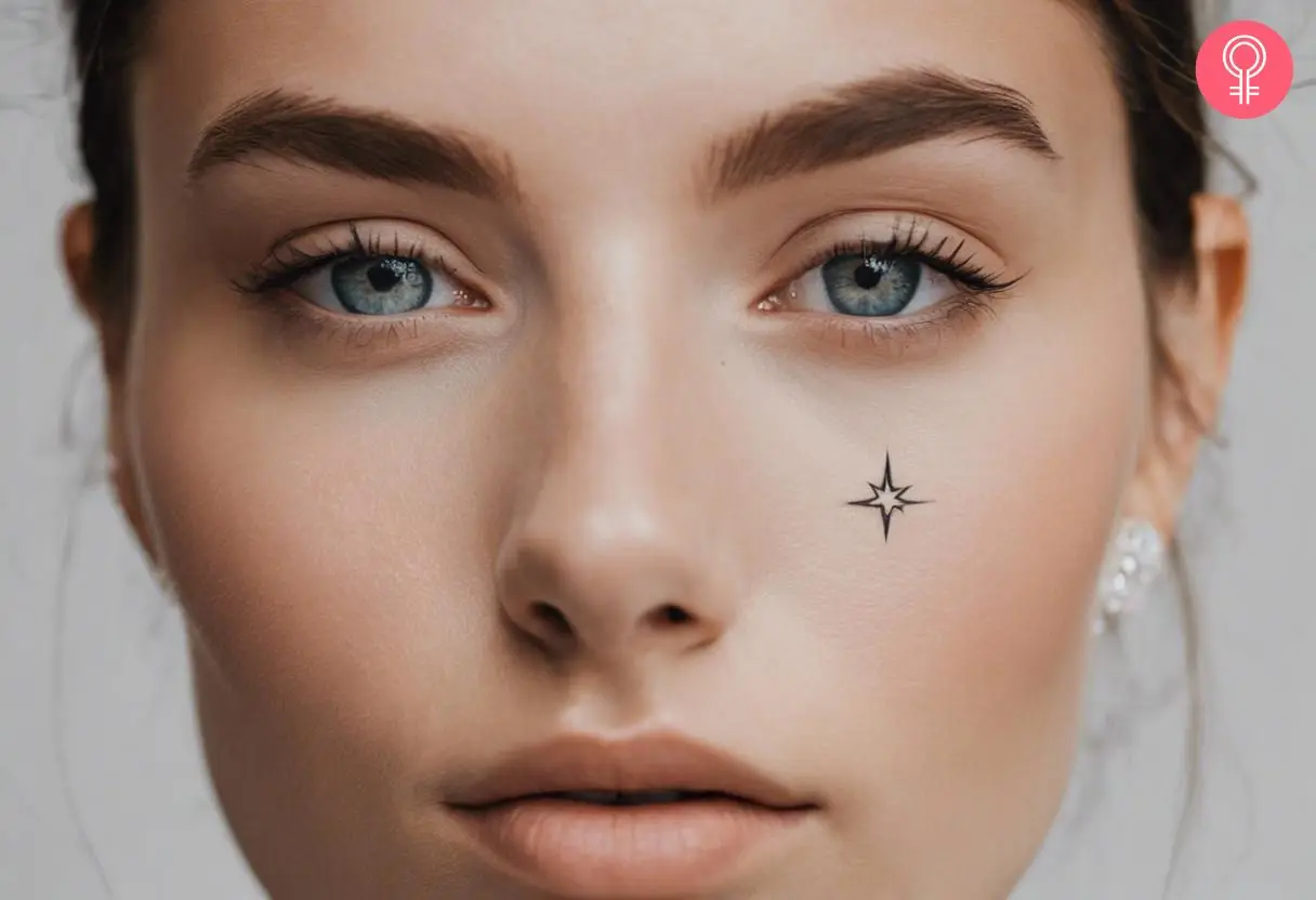 A tiny twinkling star tattoo below the eye