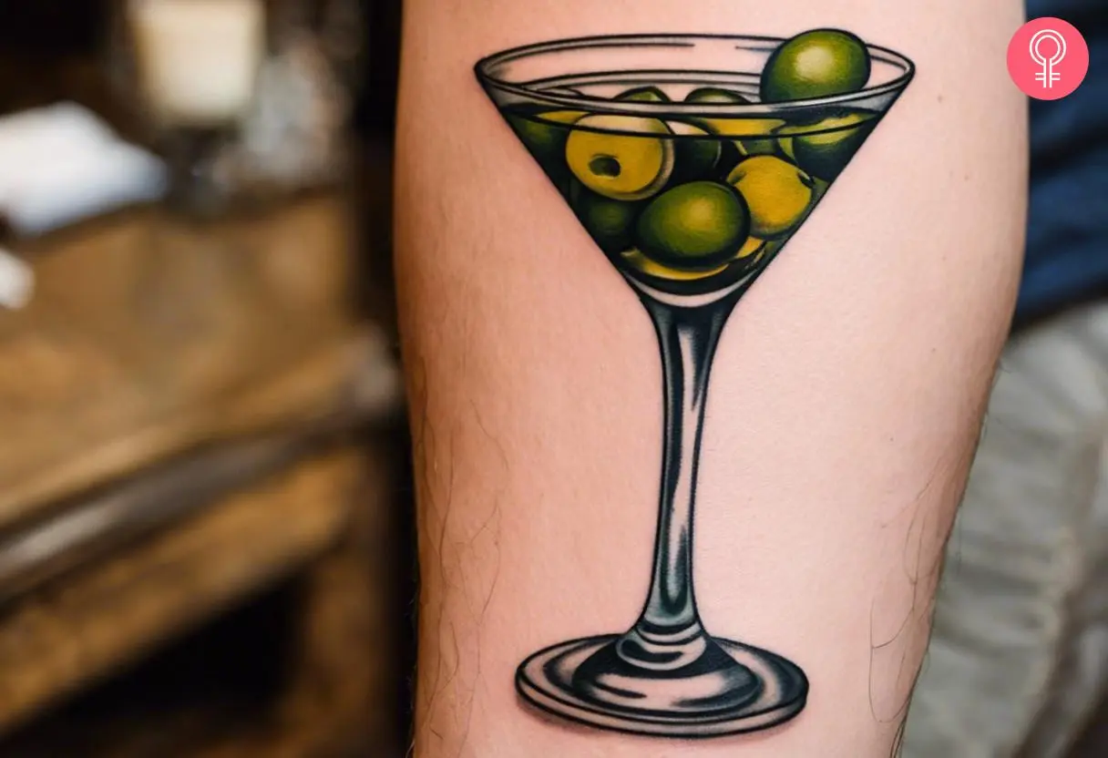 A traditional colorful marini tattoo with olives on the forearm.