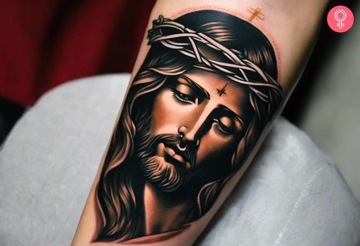 A traditional tattoo of a Jesus inked on the forearm