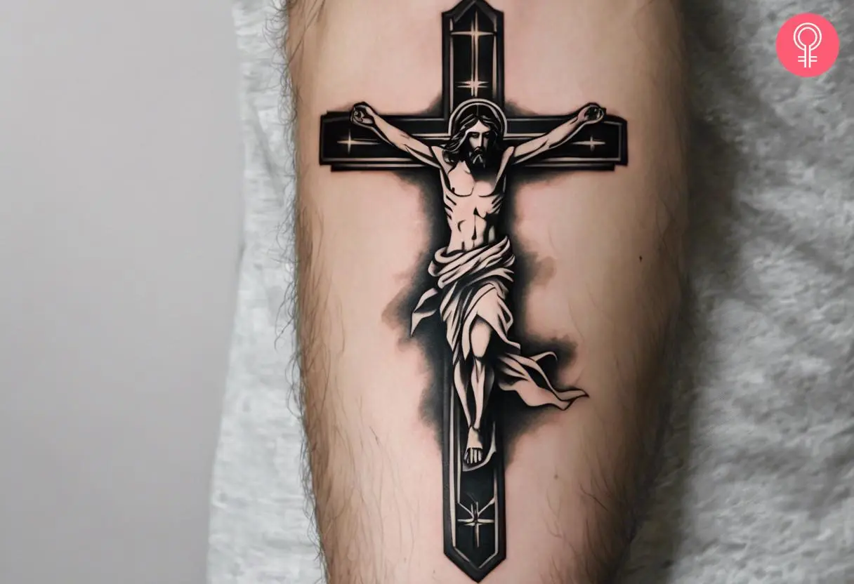 A traditional tattoo of a Jesus on the cross inked on the forearm