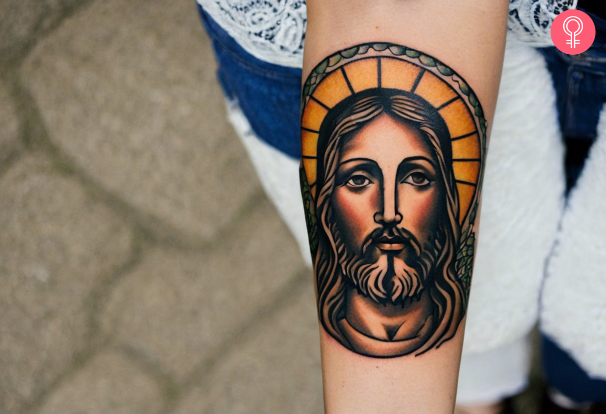 A traditional tattoo of a Jesus inked on the forearm