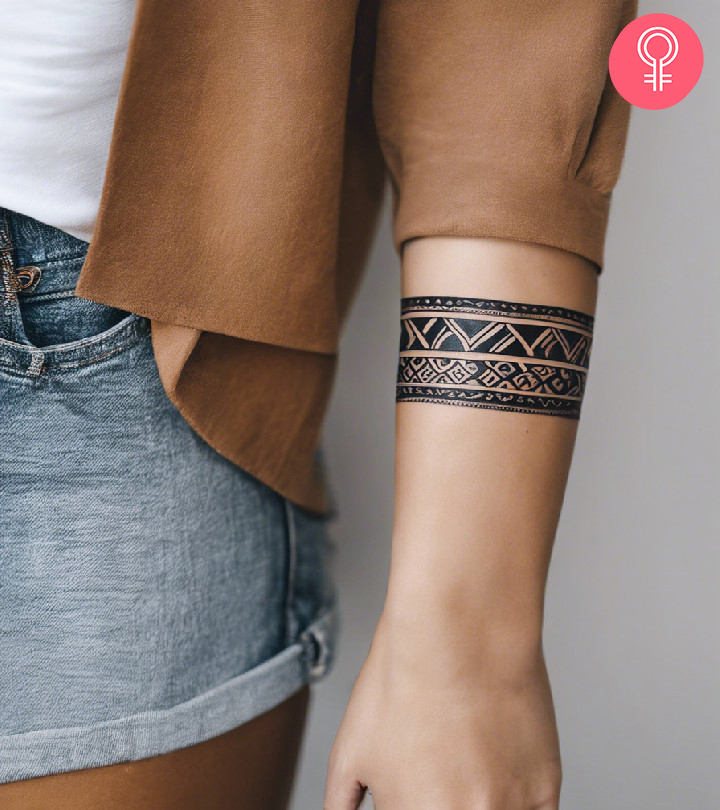 A tribal armband tattoo on the forearm