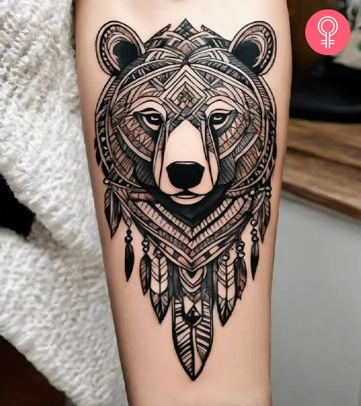 A tribal bear tattoo inked on the forearm