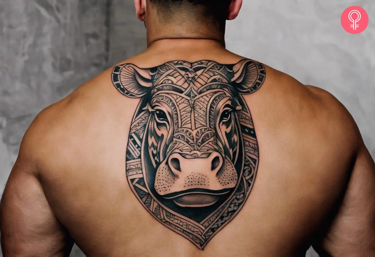 A tribal hippo tattoo on the back of a man