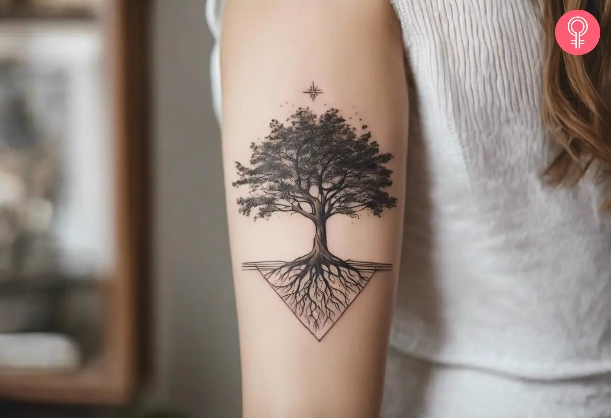 A woman flaunting an oak tree with roots tattooed on her arm