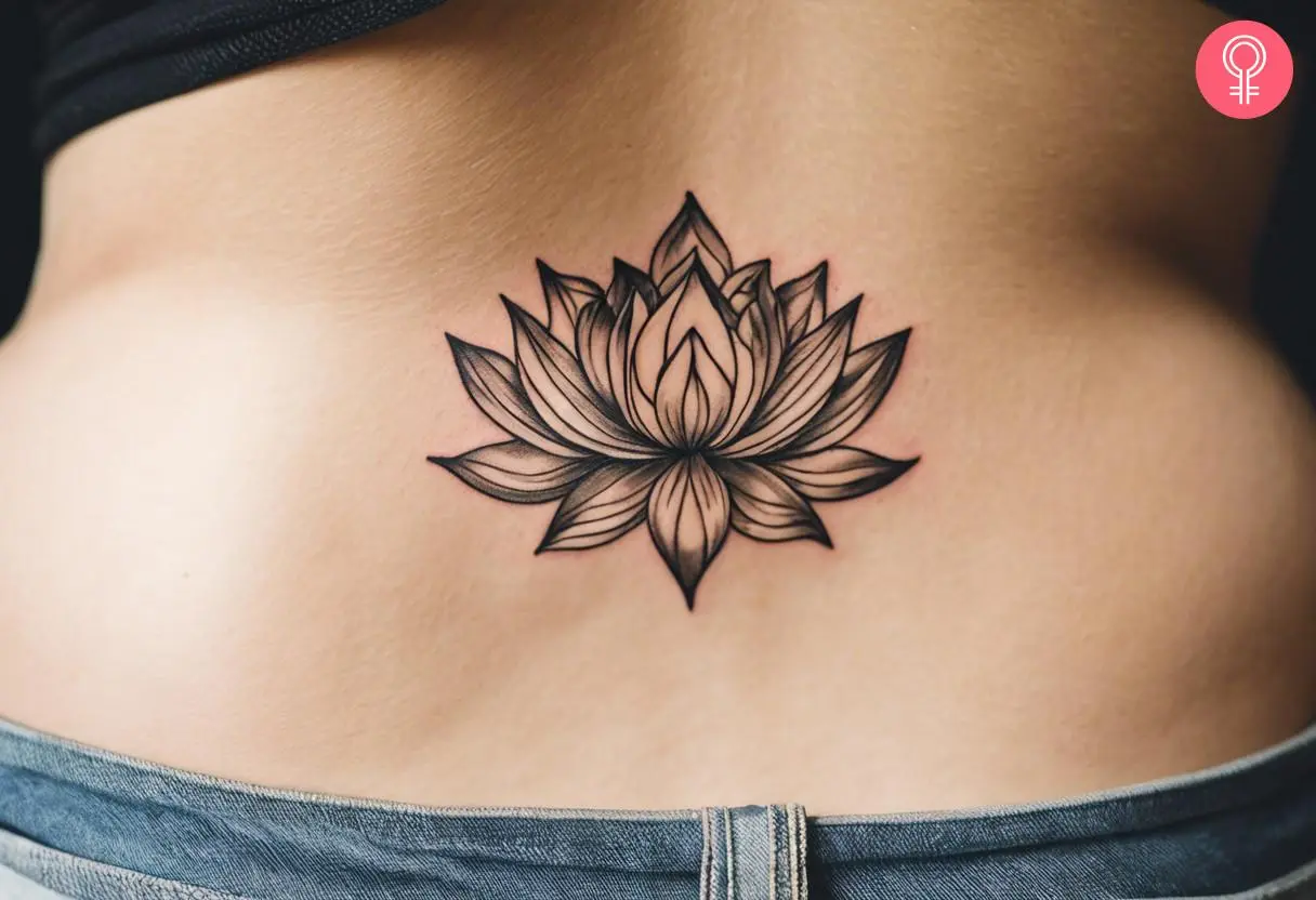 A woman wearing a lotus flower tattoo at the back