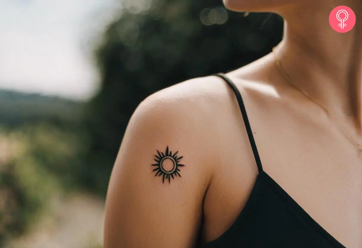 A woman wearing a sun shoulder tattoo