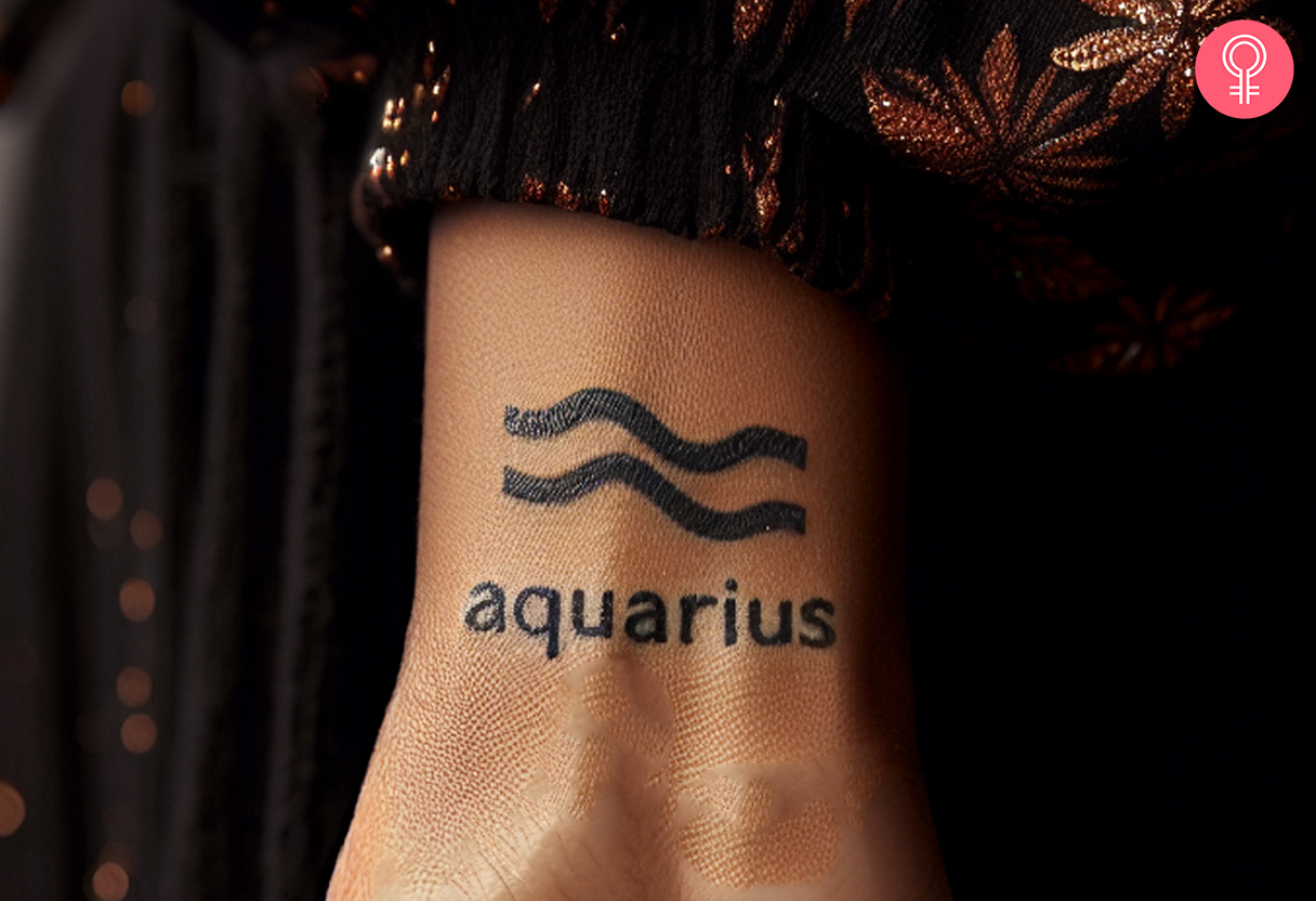 A woman wearing an Aquarius zodiac sign tattoo on the inner wrist