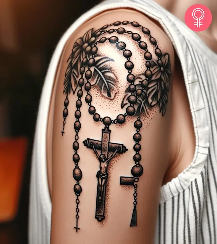 A woman with a black rosary beads tattoo on her upper arm