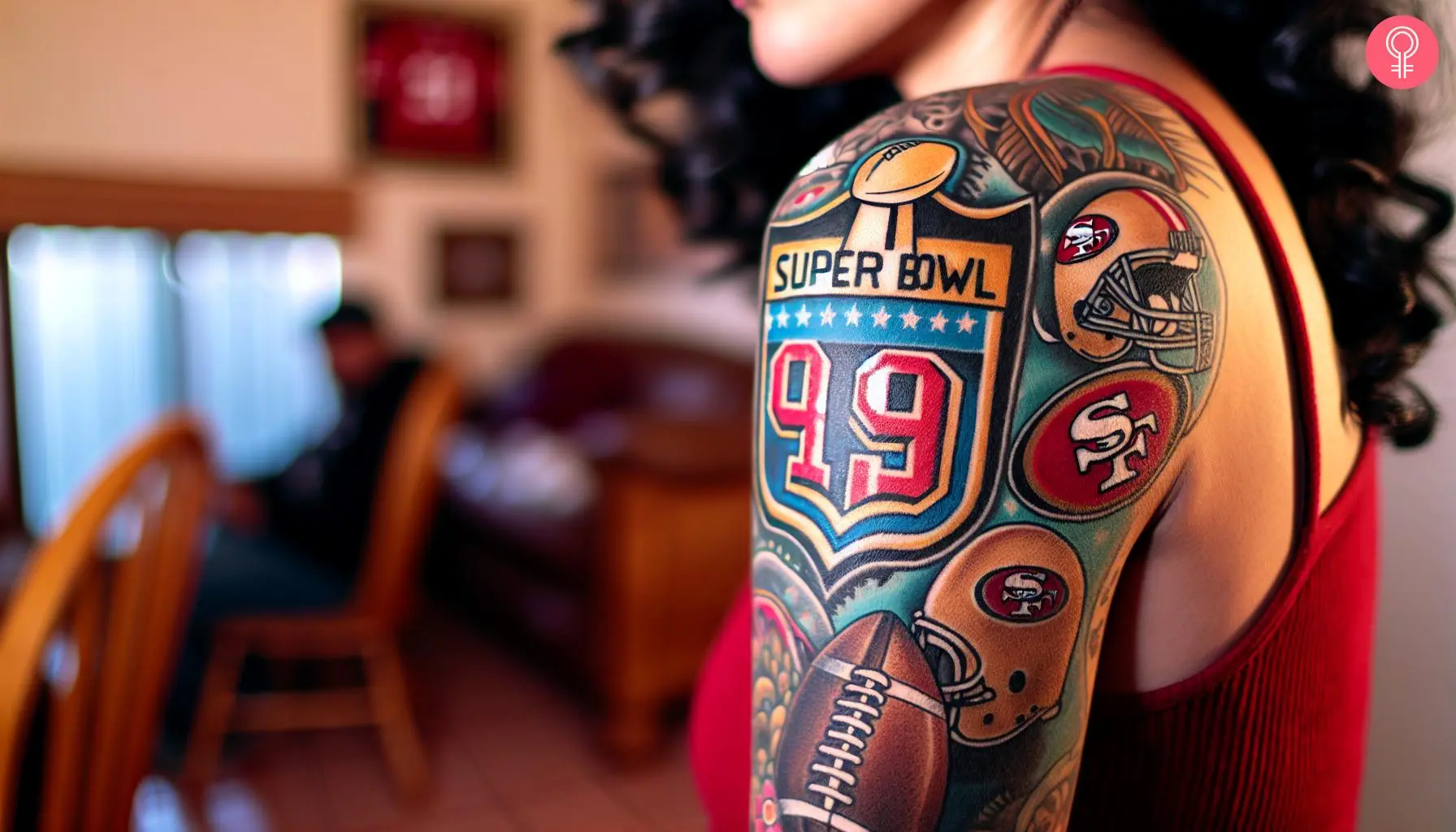 A woman with a colored 49ers super bowl tattoo on her upper arm