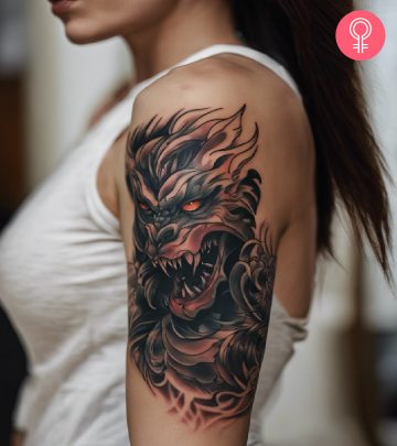 A woman with a colored monster tattoo on her upper arm