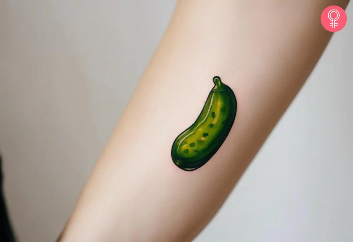 Minimalist pickle tattoo on the forearm