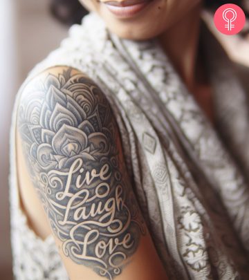 A woman with a colorful dogwood flower tattoo on her upper arm