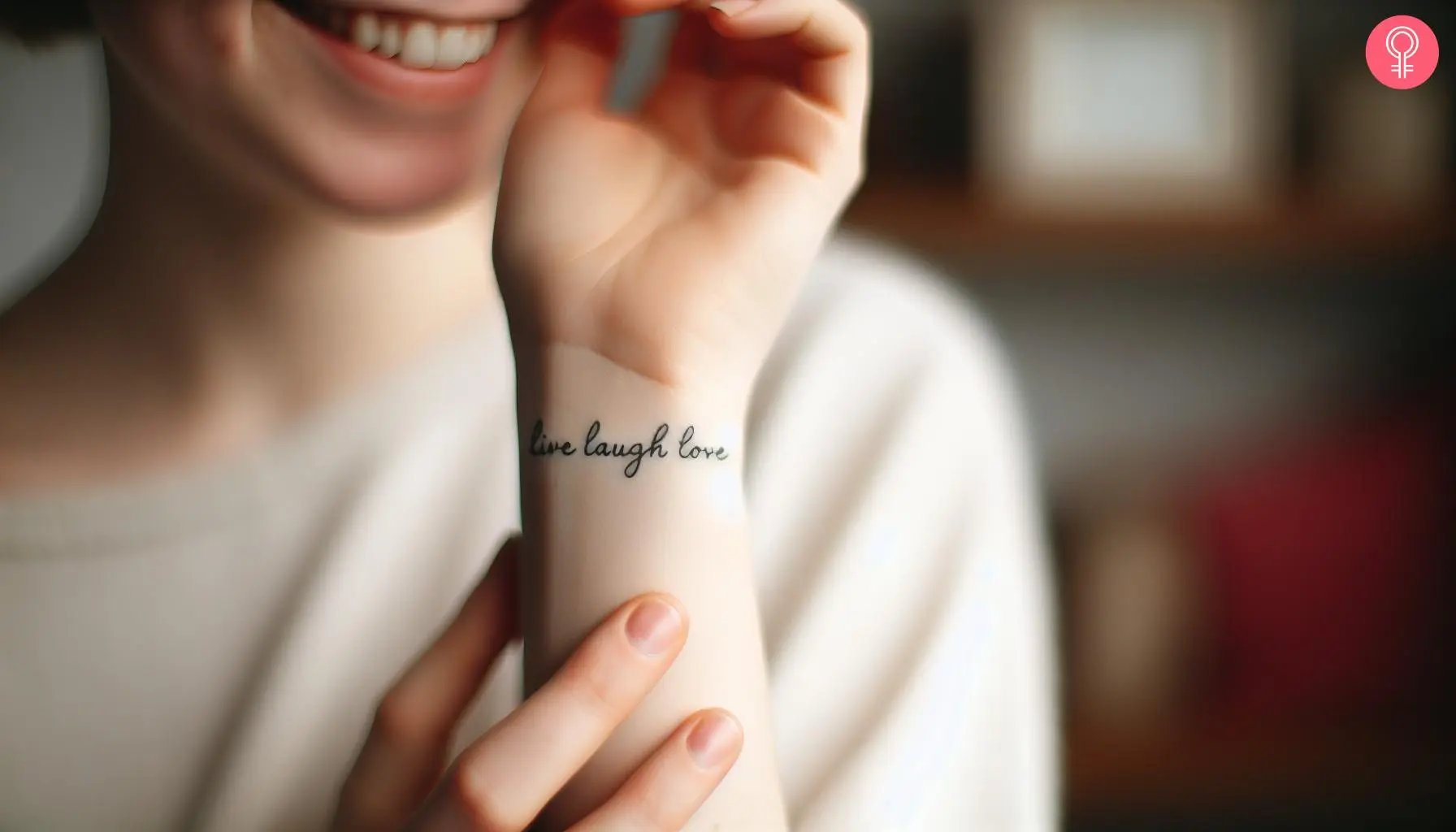 A woman with a 'live laugh love' tattoo on her wrist