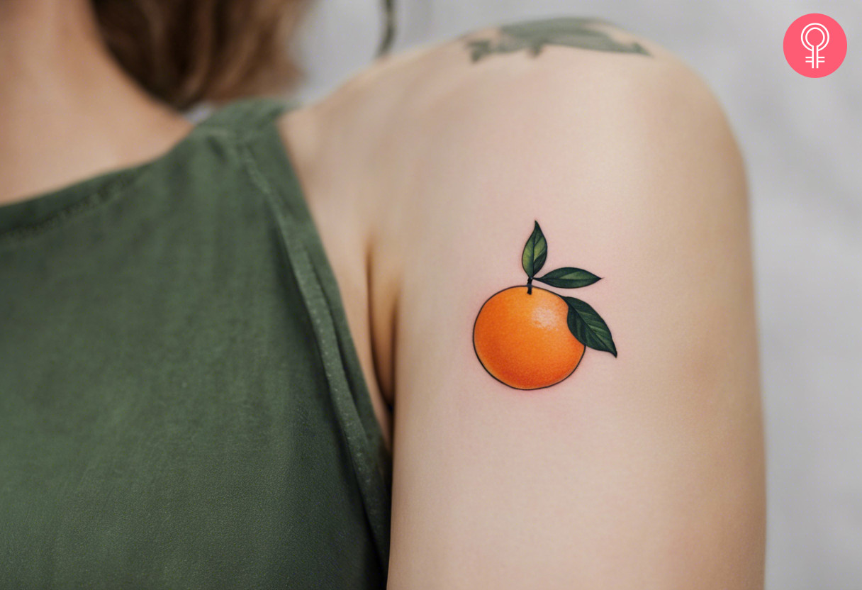 A woman with a minimalist vibrant orange tattoo on her upper arm