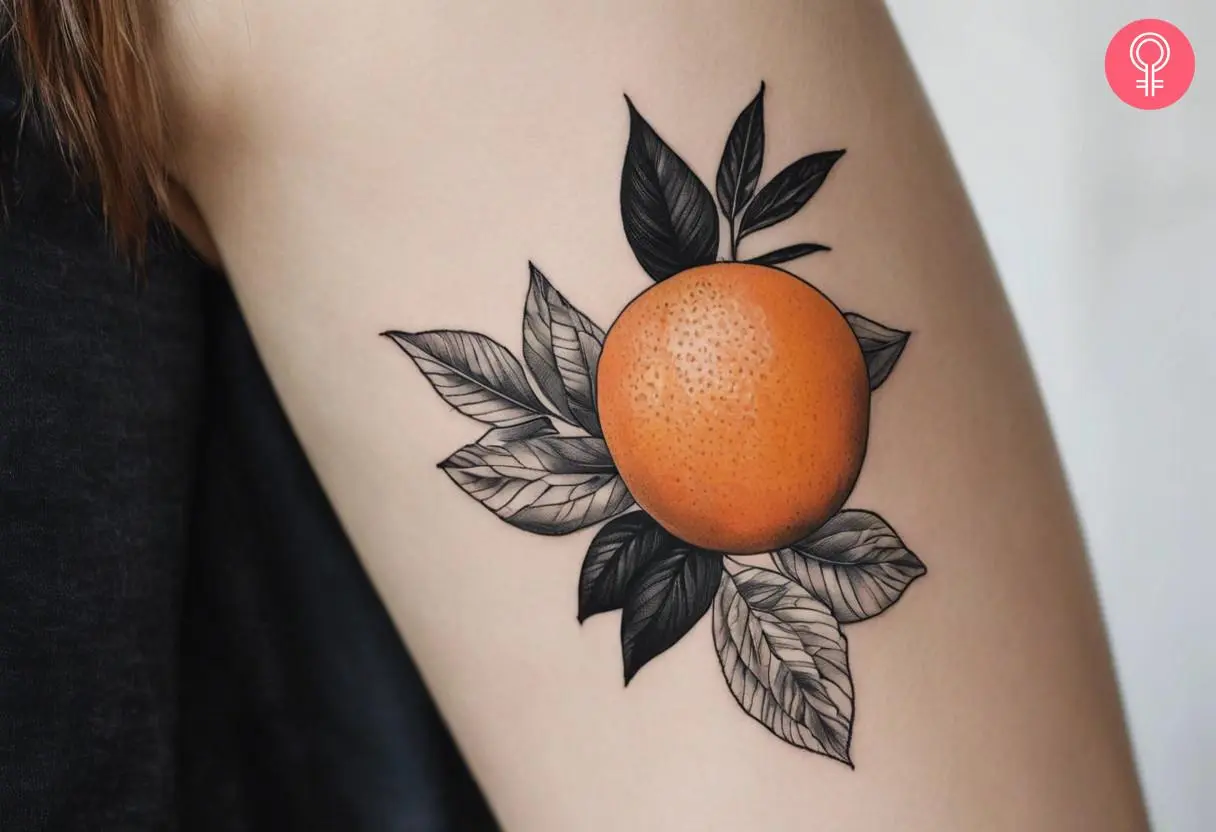 A woman with a orange black and white tattoo on her upper arm