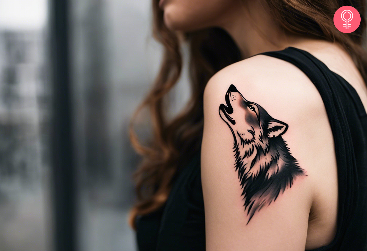 A woman with a simple howling wolf tattoo on her upper arm