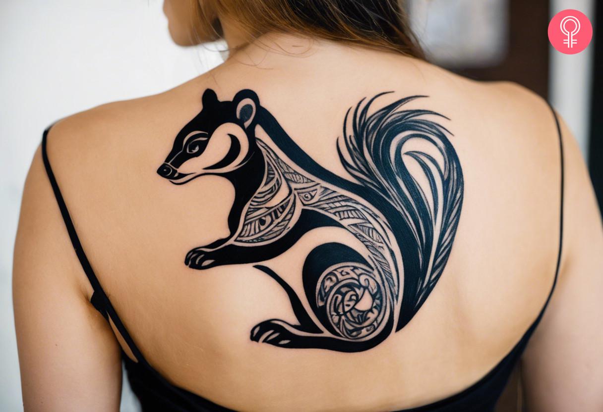 A woman with a tribal skunk tattoo on her back